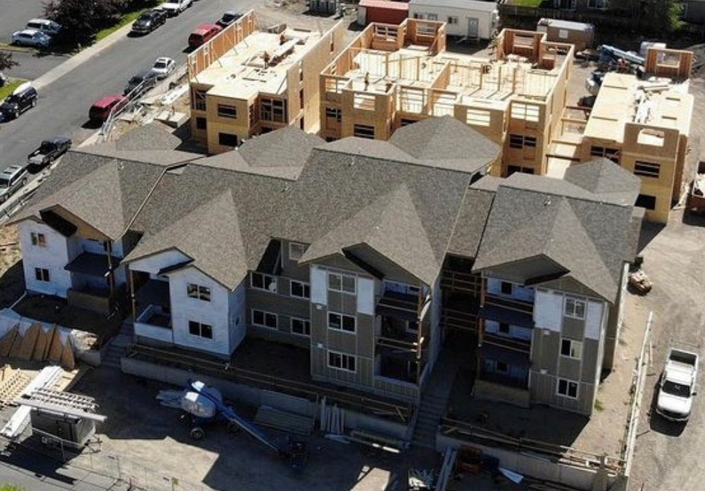 Multifamily apartment buildings undergoing construction and upgrades to improve building performance