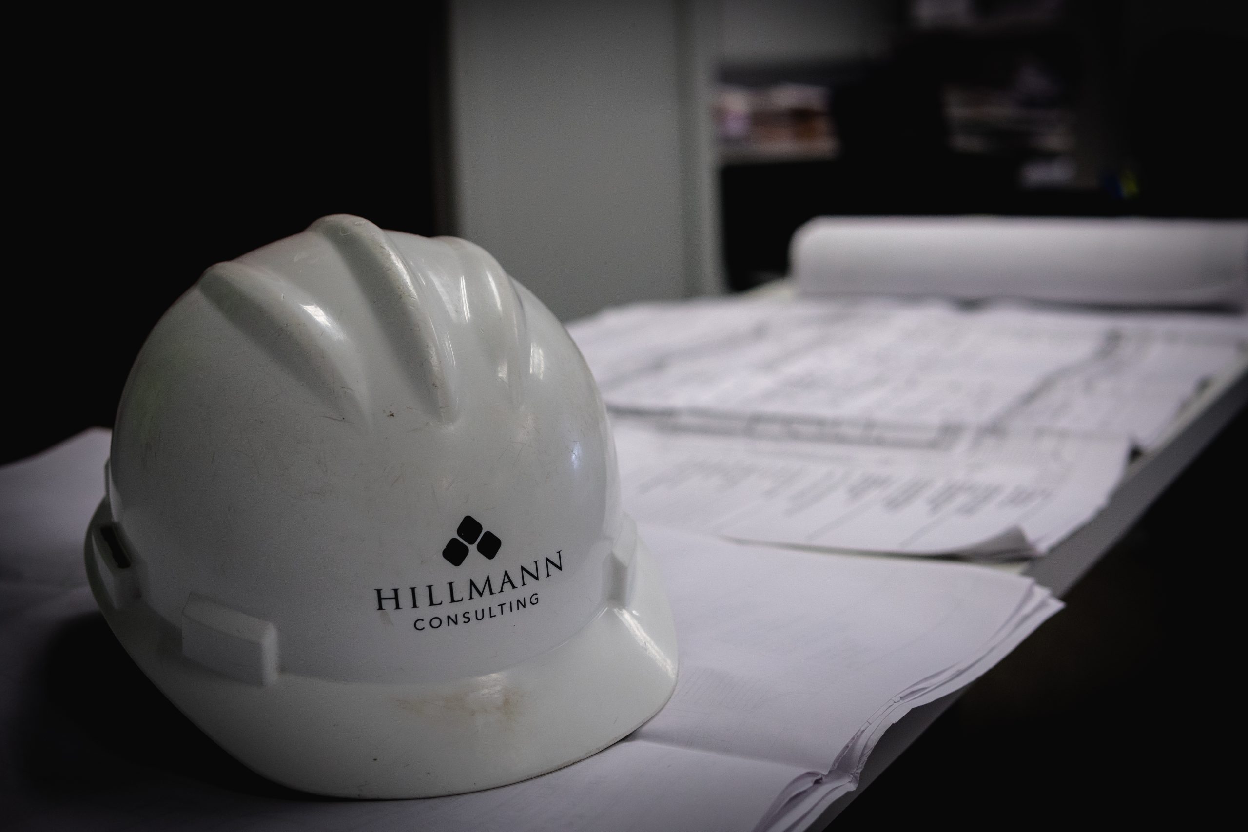 Hillmann Consulting hard hat with commercial building plans