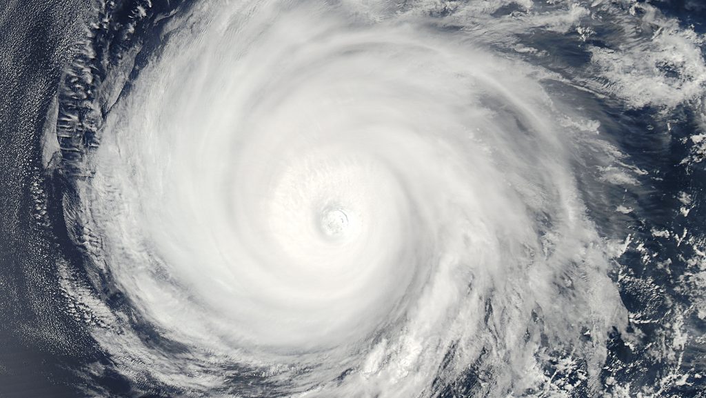 Satellite view of a powerful hurricane with a clearly defined eye and spiral cloud bands