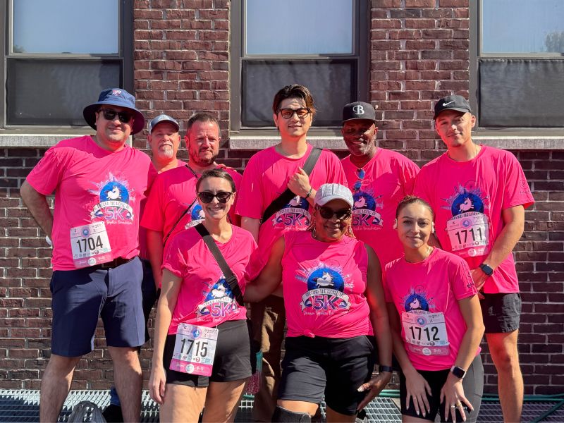 Hillmann colleagues in matching pink t-shirts doing a charity event together.