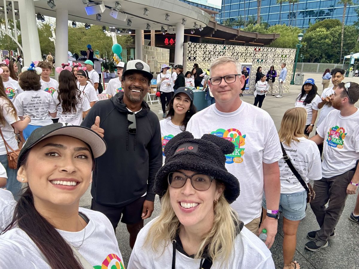 Hillmann colleagues in matching white t-shirts at Disneyland doing a charity run together. 